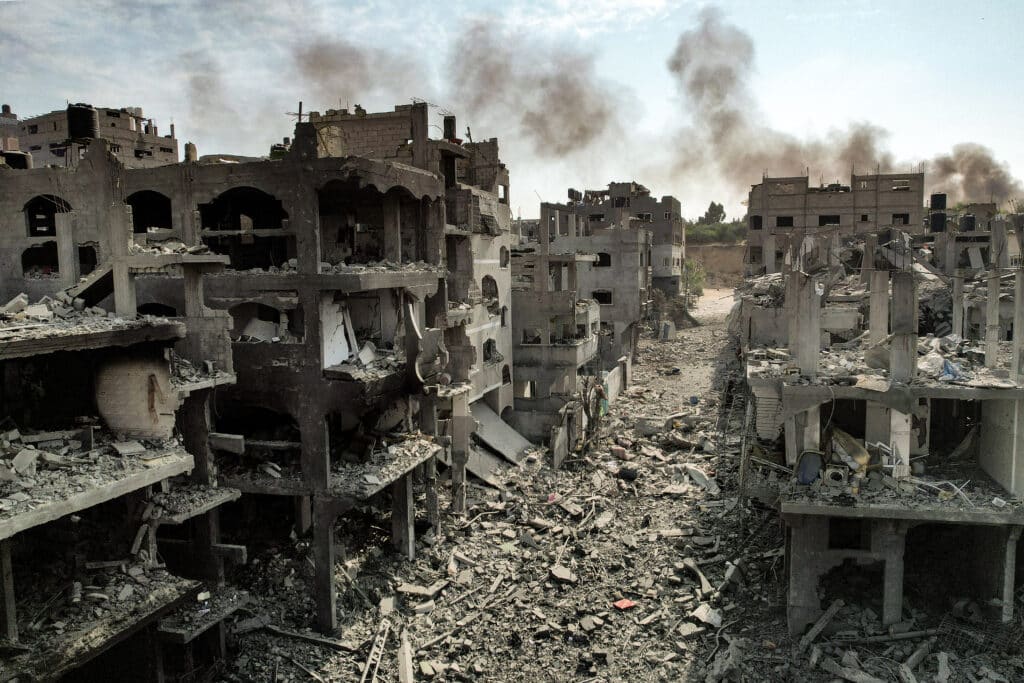 This picture taken on October 11, 2023 shows an aerial view of buildings destroyed by Israeli air strikes in the Jabalia camp for Palestinian refugees in Gaza City. Israel declared war on Hamas on October 8 following a shock land, air and sea assault by the Gaza-based Islamists. The death toll from the shock cross-border assault by Hamas militants rose to 1,200, making it the deadliest attack in the country's 75-year history, while Gaza officials reported more than 900 people killed as Israel pounded the territory with air strikes. (Photo by Yahya HASSOUNA / AFP)